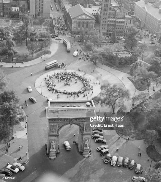 Crowd fills the roundabout in front of Washington Arch in Washington Square Park, Greenwich Village, New York.