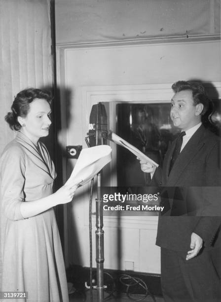 Actors Ysanne Churchman and Norman Painting recording an episode of the radio series 'The Archers' in which they play the engaged couple Grace...