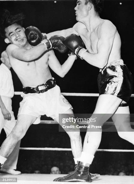 American marine Laverne Roach lands a swinging right hand on the head of Gilbert Garcia during the Inter-City Golden Gloves Championships.