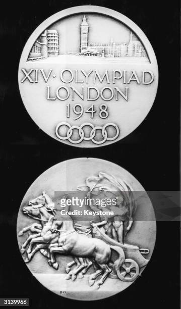 The two sides of a gold medal made for the 14th Olympic Games which are to be held in London. The medals are made from oxidised silver instead of the...