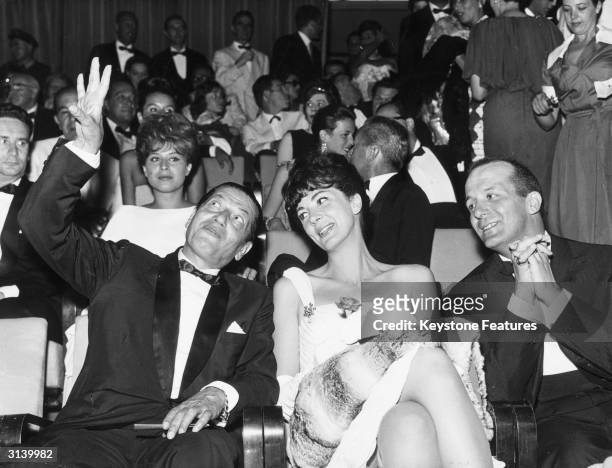 Russian ballet dancer Serge Lifar with the American opera singer Anna Moffo and the actor and director Mario Lanfranchi at the Venice film festival.