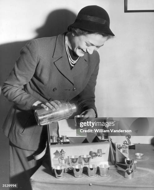 Woman demonstrating a portable cocktail bar.