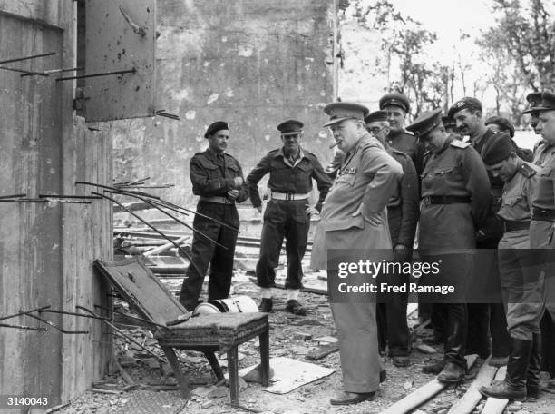 English politician and Prime Minister Winston Churchill inspecting a chair once used by Adolf Hitler during a tour of the ruins of the Chancellory in...