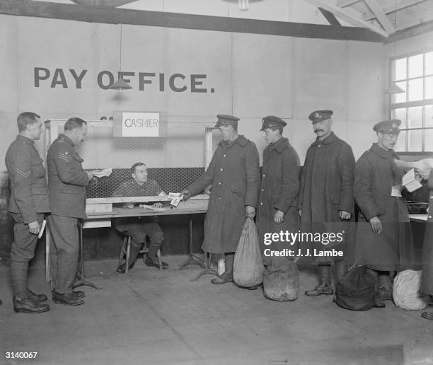 Soldiers receiving their last pay packets during demobilisation at Wimbledon.