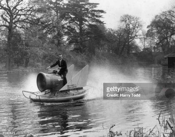 Carl Mikan, chief engineer of the Hover Scooter project, pilots the vehicle over water at Long Ditton, Surrey. The scooter rides on a six inch...