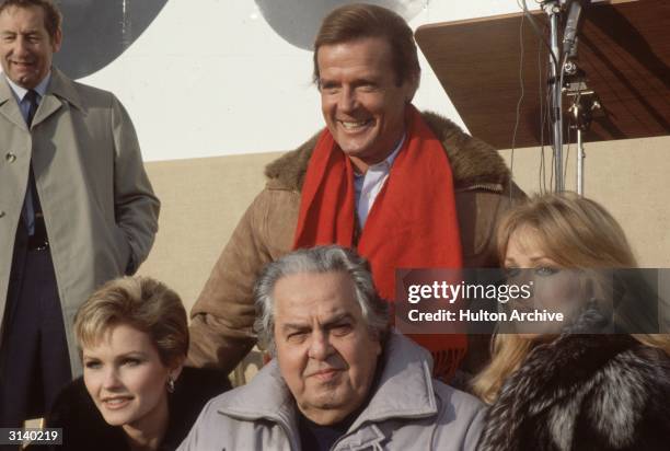 From left to right, Fiona Fullerton, producer Albert 'Cubby' Broccoli and Tanya Roberts, and behind them, a grinning Roger Moore, during the making...