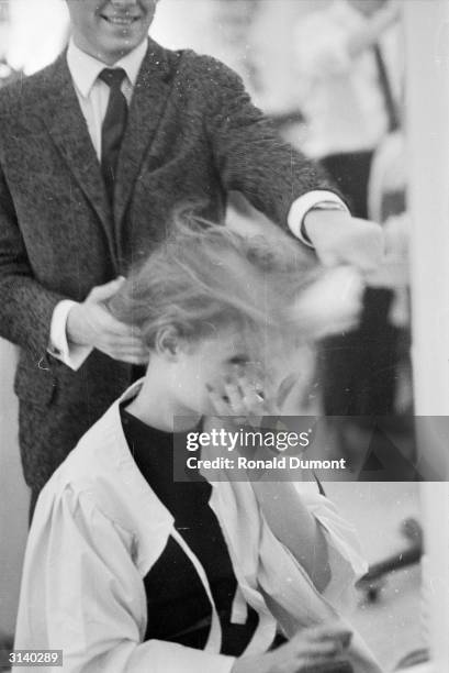 French model having her hair done backstage at a fashion show in Victoria.