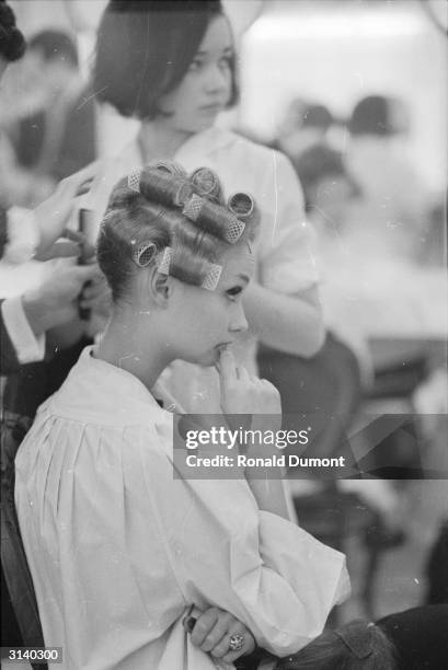 French model with her hair in curlers, backstage at a fashion show in Victoria.