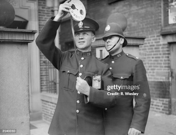 Chesterfield police photographer PC Sanders shows some film to his assistant Police Constable Wheatcroft.