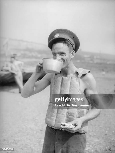 Soldier from the 4th Division Royal Engineers at Wouldham Camp near Rochester, stripped to the waist but wearing a lifejacket because he is employed...