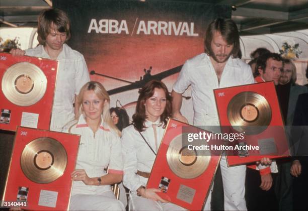 Pop group Abba holding their golden discs. From l to r; Benny Andersson, Agnetha Faltskog, Anni-Frid Lyngstad and Bjorn Ulvaeus. A Swedish group...