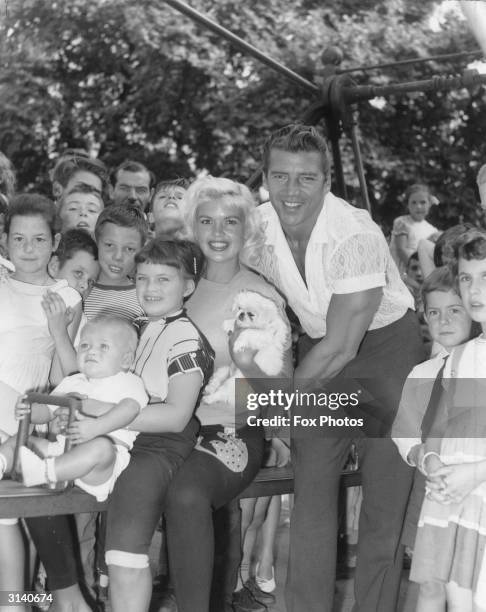 Hollywood sex symbol Jayne Mansfield and her family playing in St James' Park, London, during a break from filming 'Too Hot To Handle'. With her are...