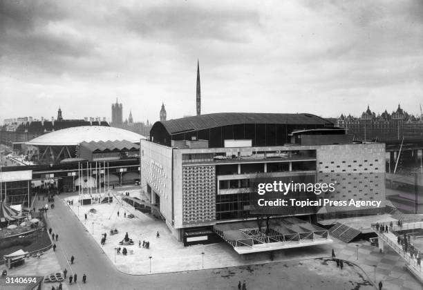 The Royal Festival Hall at the time of the Festival of Britain with the Dome of Discovery' and the Skylon. In the background are the Houses of...