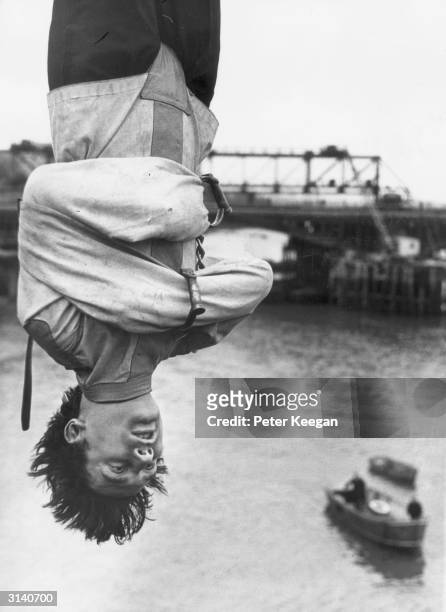Escapologist Timothy Dill-Russell, adviser to the musical 'Man of Magic' about Houdini, is strapped in a straight-jacket as he hangs upside down over...