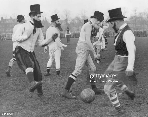 Dressed as Victorian gentlemen complete with top hats and beards, fifteen students from Caius College, Cambridge and fifteen from Oxford play...