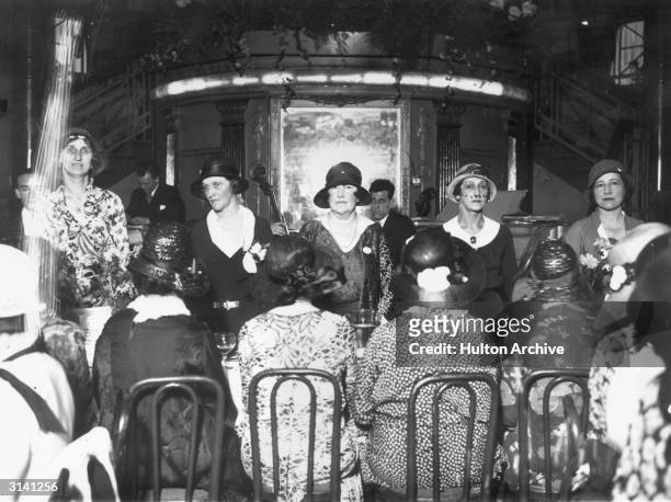American born Viscountess Astor MP the principal guest at a lunch in the Cafe de Paris organised for the National Council of Girls Clubs is standing...
