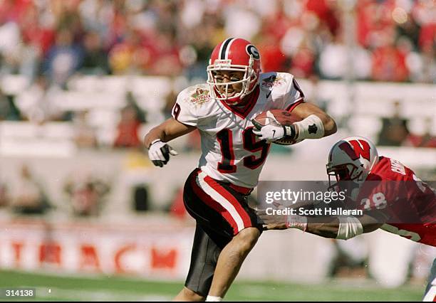 Wide receiver Hines Ward of the Georgia Bulldogs moves the ball during the Outback Bowl against the Wisconsin Badgers at Houlihan''s Stadium in...