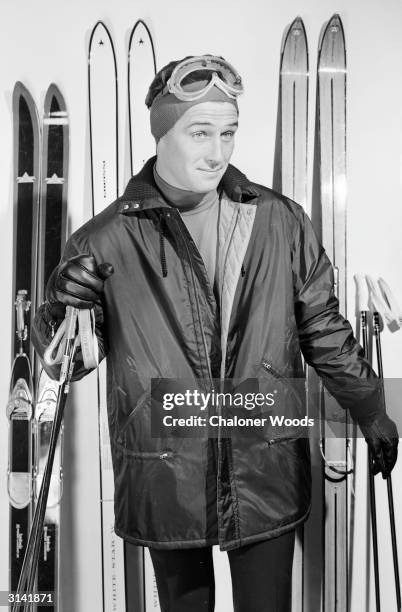 Ski wear of zipped nylon jacket, rollneck sweater, bandeau and ski-goggles.