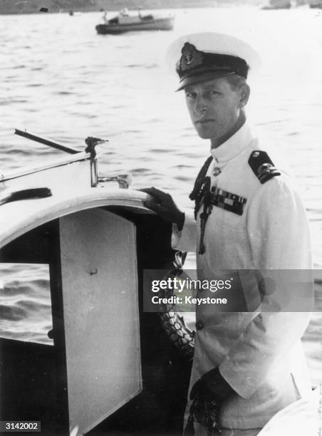 Prince Philip, Duke of Edinburgh in naval uniform on a boat in Malta.