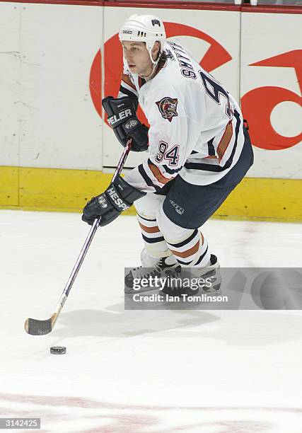 Ryan Smyth of the Edmonton Oilers skates with the puck against the Calgary Flames on March 9, 2004 at The Pengrowth Saddledome in Calgary, Alberta....