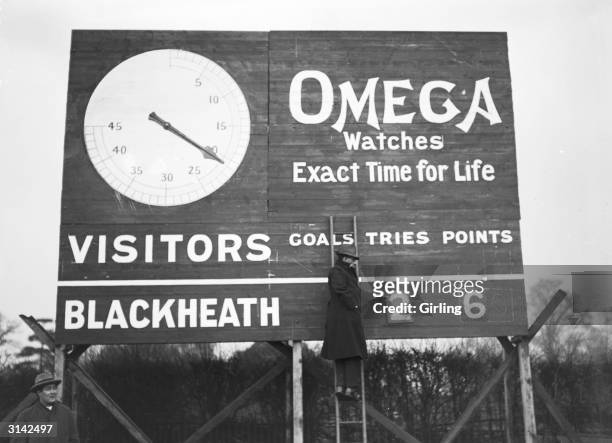 Updating the Omega scoreboard during the match between Blackheath and the Army at Blackheath rugby ground, London.