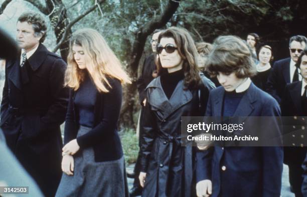 Jackie Onassis , the widow of murdered President John F. Kennedy, flanked by her children Caroline and John F. Kennedy Jr. At the funeral of her...