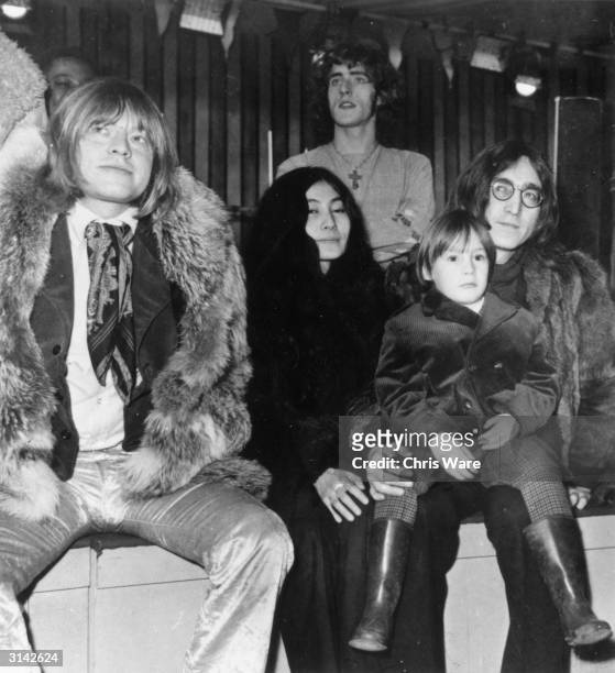 From l to r; Rolling Stone, Brian Jones with Yoko Ono, John Lennon of the Beatles and the latter's son, Julian at a Wembley studio. Standing behind...