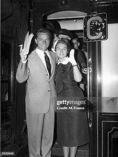 Richard Burton with his first wife, Sybil Williams leaving Waterloo station in London on the Queen Mary boat train.