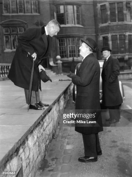 On the left Sir Henry Channon, Conservative MP talking to Peter Thorneycroft after a party meeting in Church House, Westminster at which Harold...