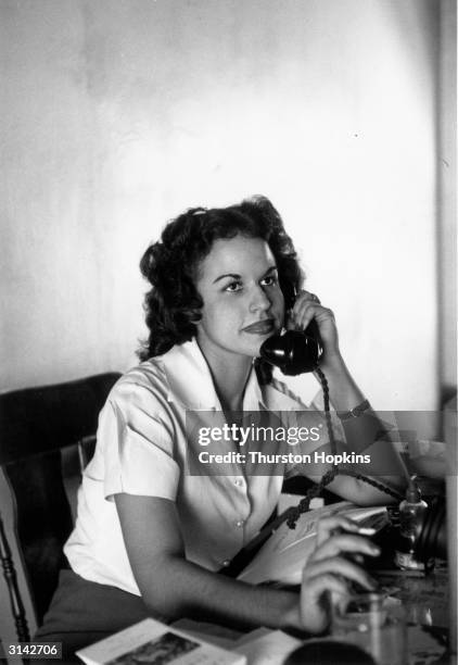 Evelyn Anarade, Miss Jamaica 1953, working as a secretary. Original Publication: Picture Post - 6832 - The Royal Tour: From Bermuda To Jamaica - pub....