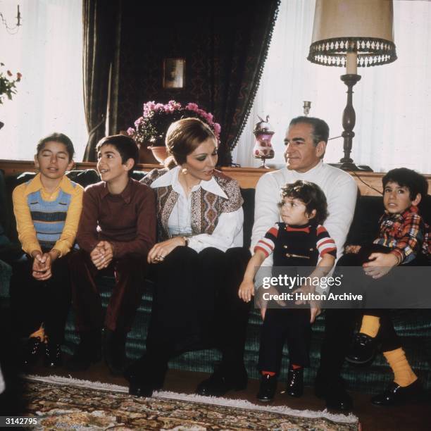 The Shah of Iran with his third wife Farah Diba and their children, Prince Reza, Prince Ali Reza and the two younger children, Princess Farahnaz and...