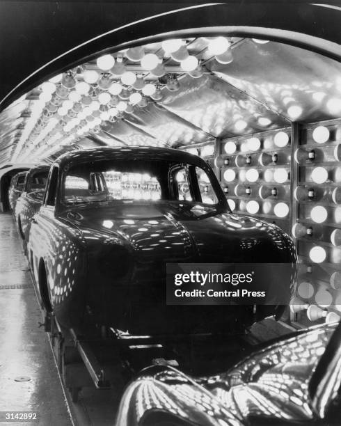 Gleaming Renault 'Dauphines' passing through the infra-red drying cabinet after their visit to the paint shop at the Renault factory in France.