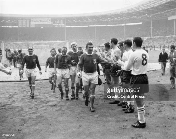 Members of the England team applauding Rest of the World players as they come off the field after the Football Association Centenary Match at...