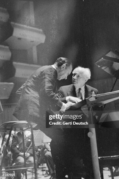 German pianist Wilhelm Backhaus and Sir John Barbirolli discuss the score during rehearsal for a concert with the Halle Orchestra at the Royal...