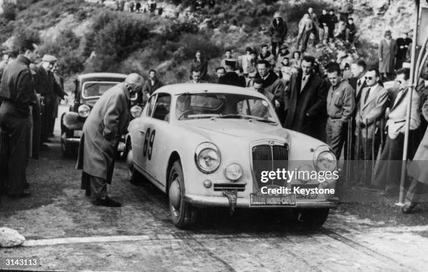 Louis Chiron in his 2.5 litre Lancia at the start of the last test of the Monte Carlo Rally. Chiron's car was later the subject of controversy after...