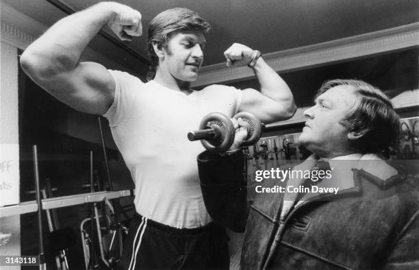 Potential client admires Dave Prowse who works in the keep-fit department of Harrods. He also plays the role of Darth Vader in Star Wars.