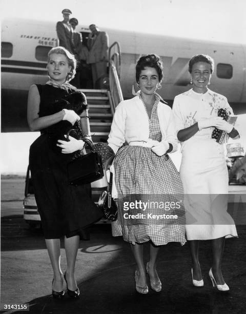 British born American actress Liz Taylor arrives in New York International Airport with fellow actresses Grace Kelly and Lorraine Day.