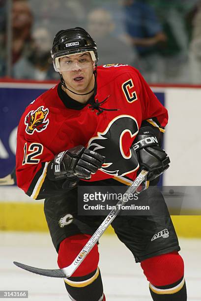 Jarome Iginla of the Calgary Flames eyes the play as he skates against the Edmonton Oilers on March 9, 2004 at The Pengrowth Saddledome in Calgary,...