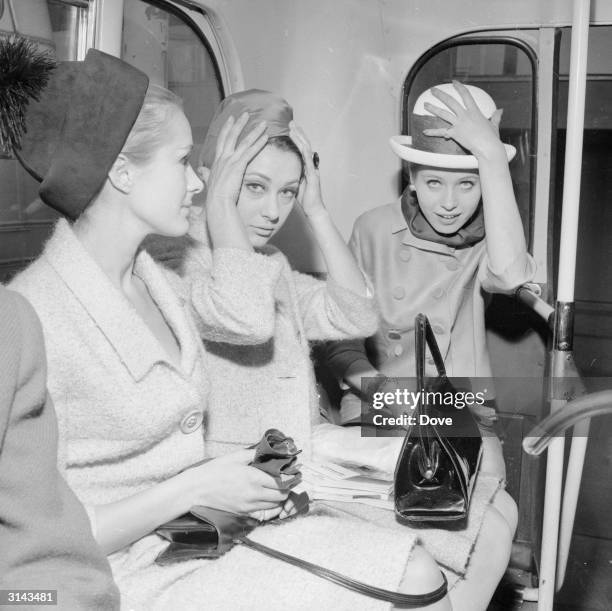 Air hostesses Aldine Honey, Ann Lloyd James and Ann Renvoize prepare to board a BEA passenger plane for Paris.