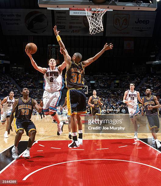 Jason Williams of the Memphis Grizzlies drives to the basket against Reggie Miller of the Indiana Pacers during the game at The Pyramid on March 20,...