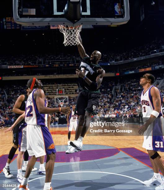 Kevin Garnett of the Minnesota Timberwolves dunks during the game against the Phoenix Suns at America West Arena on March 19, 2004 in Phoenix,...