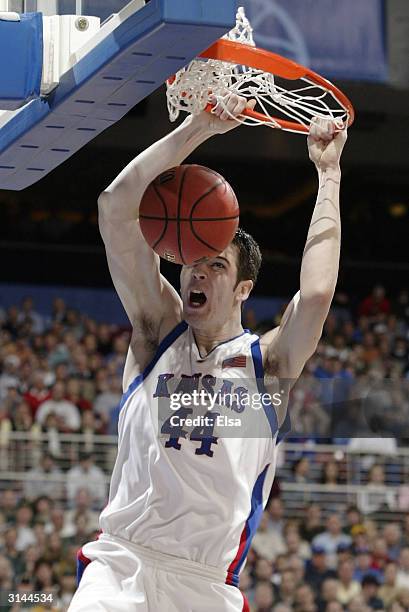 David Padgett of the Kansas Jayhawks dunks in the first half against the Alabama-Birmingham Blazers during the third round game of the NCAA Division...