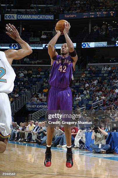 Donyell Marshall of the Toronto Raptors shoots against the New Orleans Hornets during the game at New Orleans Arena on March 21, 2004 in New Orleans,...