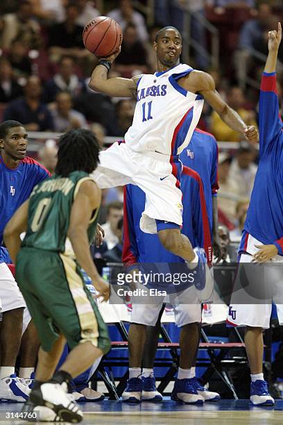 Aaron Miles of the Kansas Jayhawks throws the ball in bounds as Carldell Johnson of the Alabama-Birmingham Blazers defends during the third round...