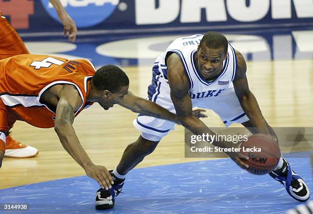 Luther Head of the Illinois Fighting Illini tries to punch the ball away from Daniel Ewing of the Duke Blue Devils during the third round game of the...