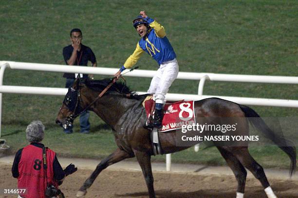 Jockey Alex Solis on Pleasantly Perfect celebrates his victory over fellow American Jerry Bailey on Medaglia d'Oro at the Dubai World Cup 27 March...