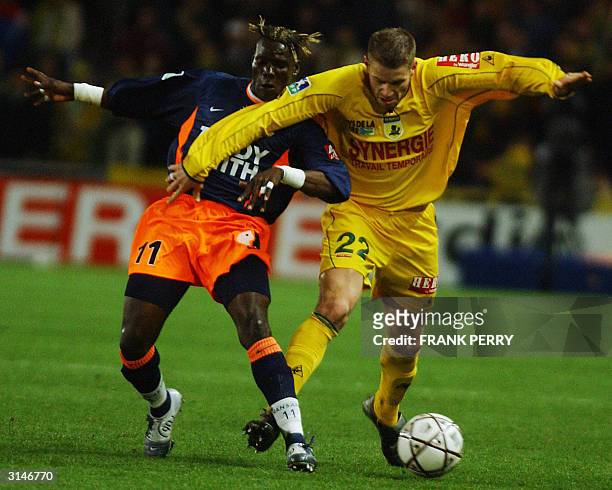 Nantes's defender Sylvain Armand vies with Montpellier's Guinean forward Fode Mansare during their French first league football match, 27 March 2004...