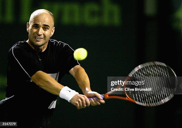 Andre Agassi of the USA plays a backhand during his straight sets victory over Mariano Zabaleta during the second round on March 27, 2004 at the...