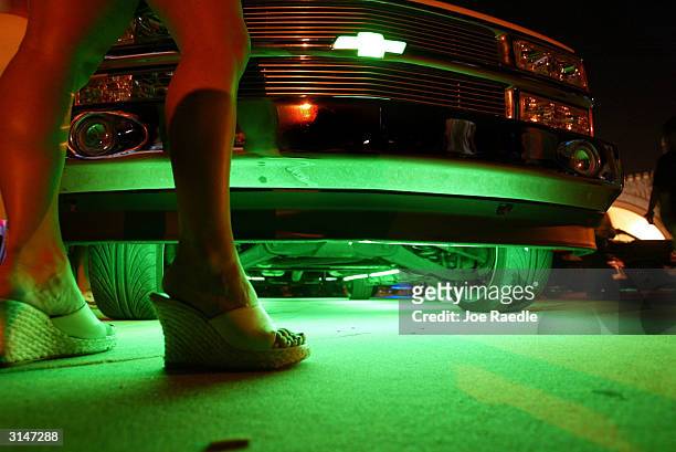 Neon glows from under a truck during the Spring Break Nationals Glowoff Competition March 27, 2004 in Daytona Beach, Florida. A glow-off is a...