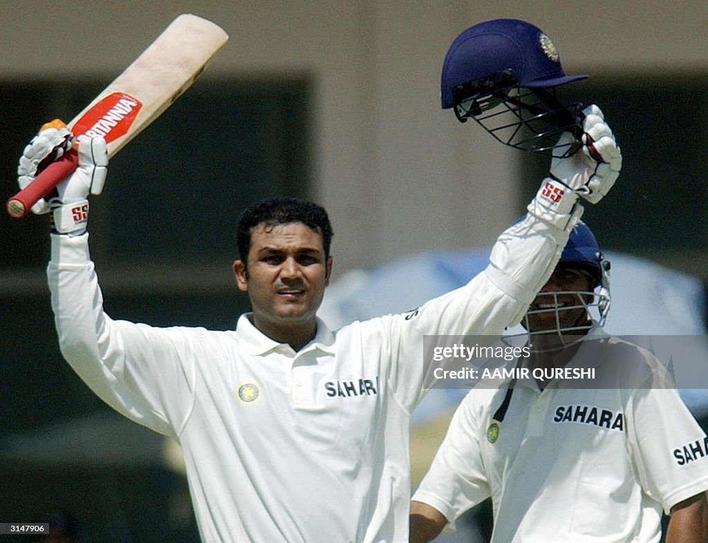 Indian Batsman Virender Sehwag Celebrates His Century As His Teammate indian-batsman-virender-sehwag-celebrates-his-century-as-his-teammate